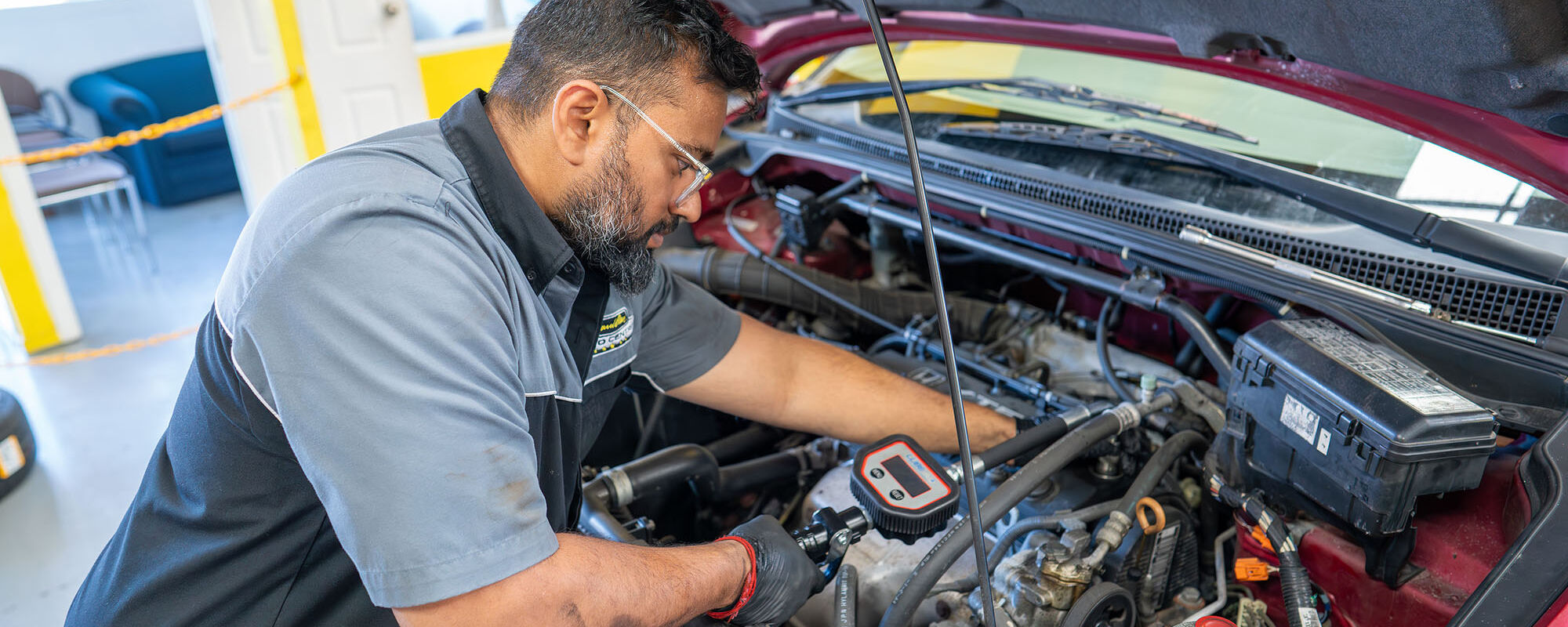 Mechanic performing a vehicle service at Hamilton Auto Centre workshop in Te Rapa