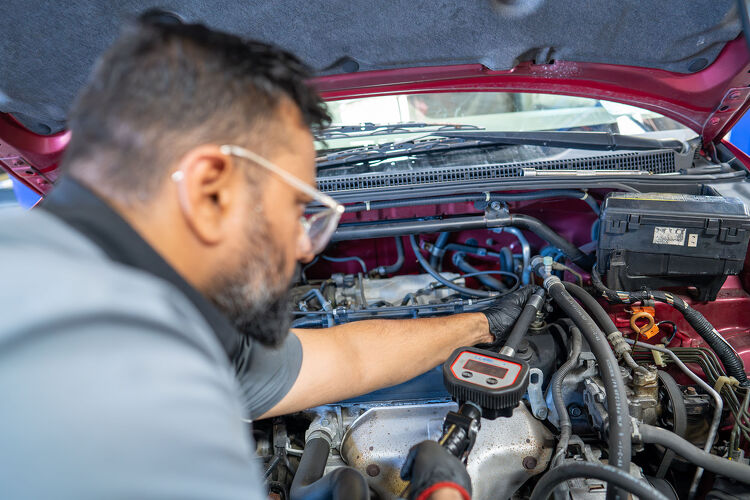 Close-up of a Hamilton Auto Centre mechanic performing engine diagnostics