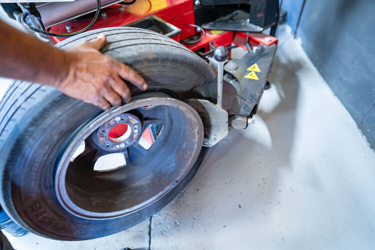 Used tyre being removed from rim using tyre changer at Hamilton Auto Centre