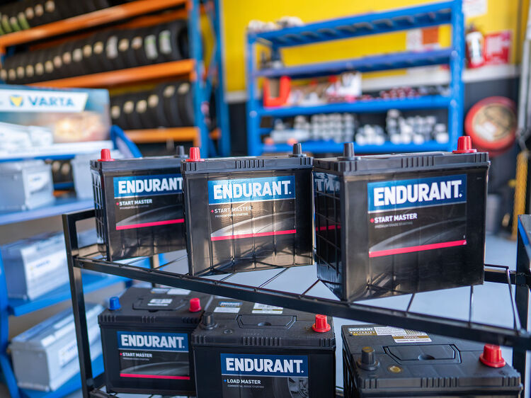 Endurant car batteries neatly stacked on a rack at Hamilton Auto Centre