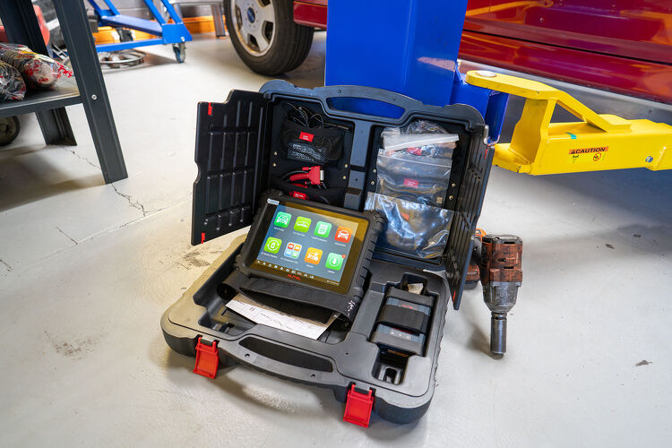 Vehicle diagnostic scan tool open on workshop floor at Hamilton Auto Centre